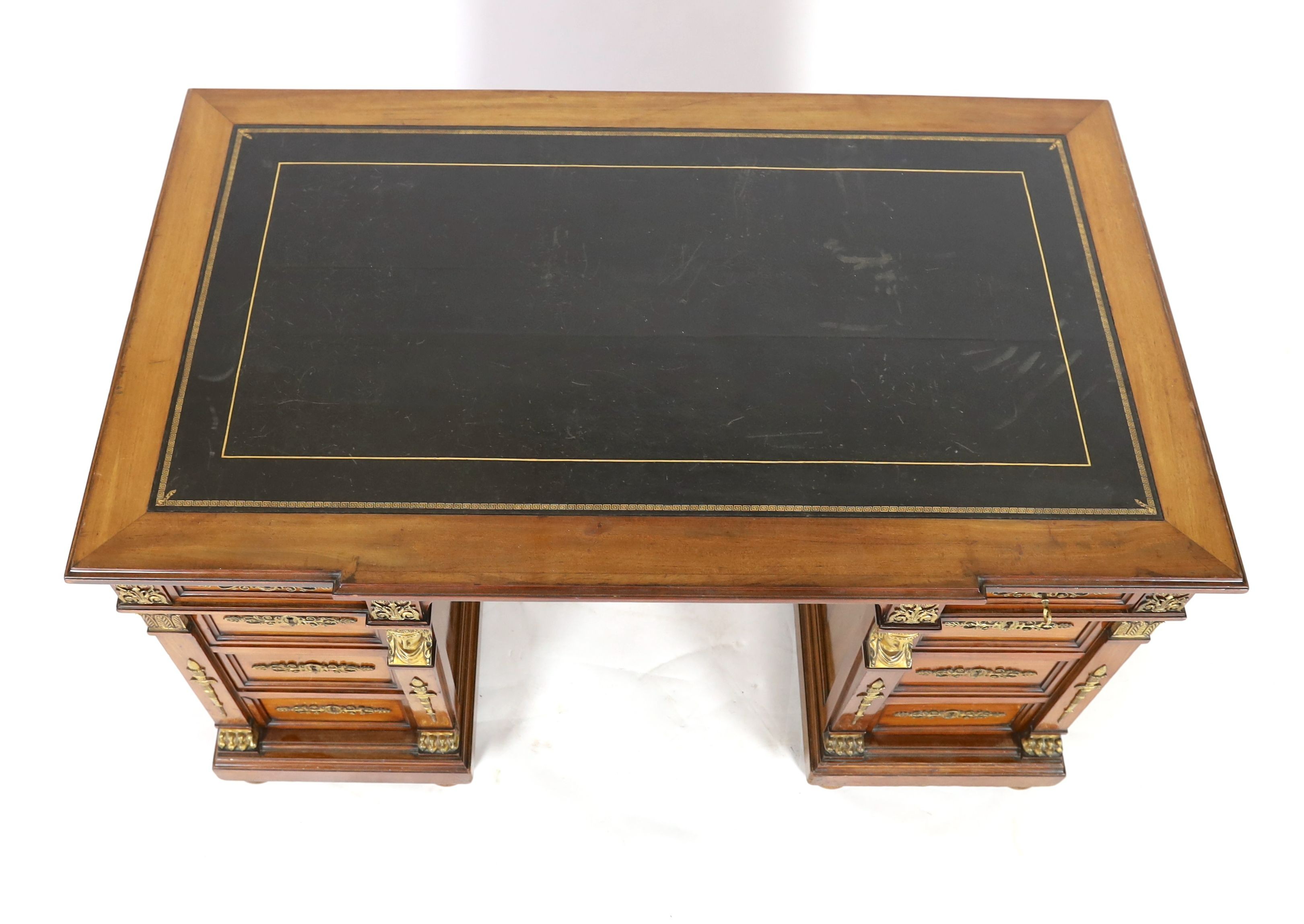 An early 20th century French classical revival mahogany breakfront pedestal desk, W.135cm D.82cm H.75cm